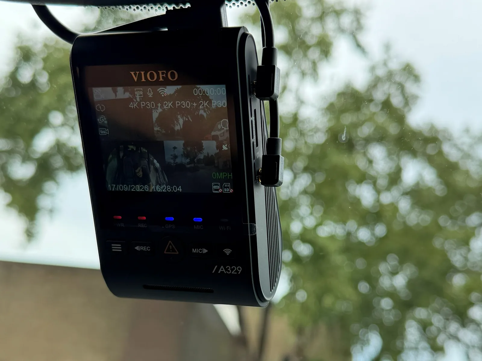 VIOFO dash camera mounted behind the mirror, screen showing live 4K recording